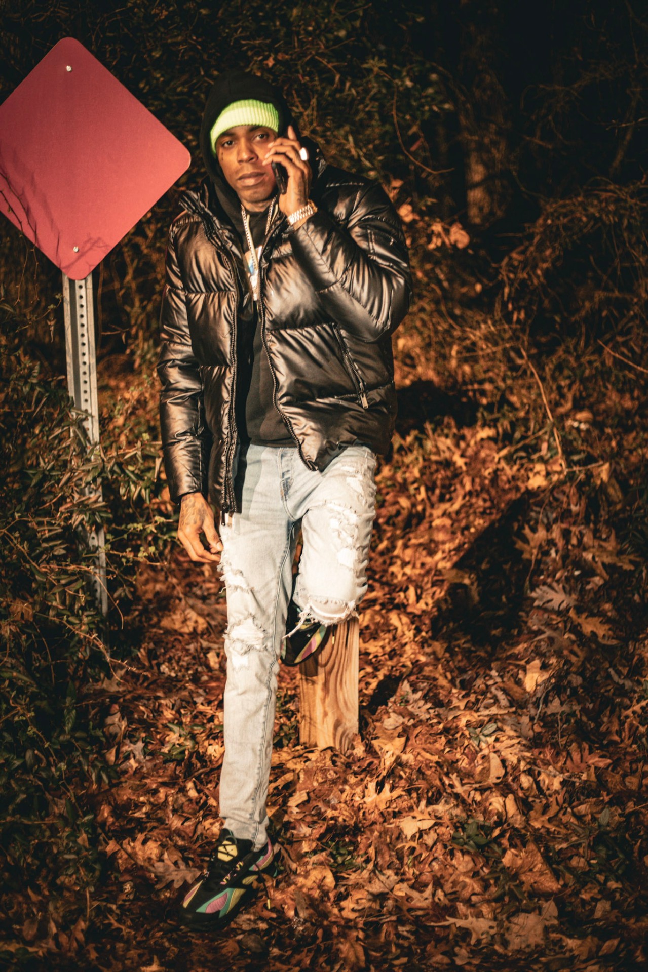 Puffer jacket portrait on the phone in the leaves