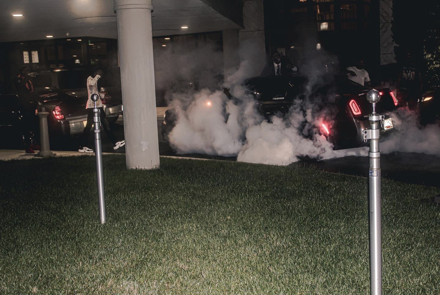 Late-night arrival, smoke under the portico