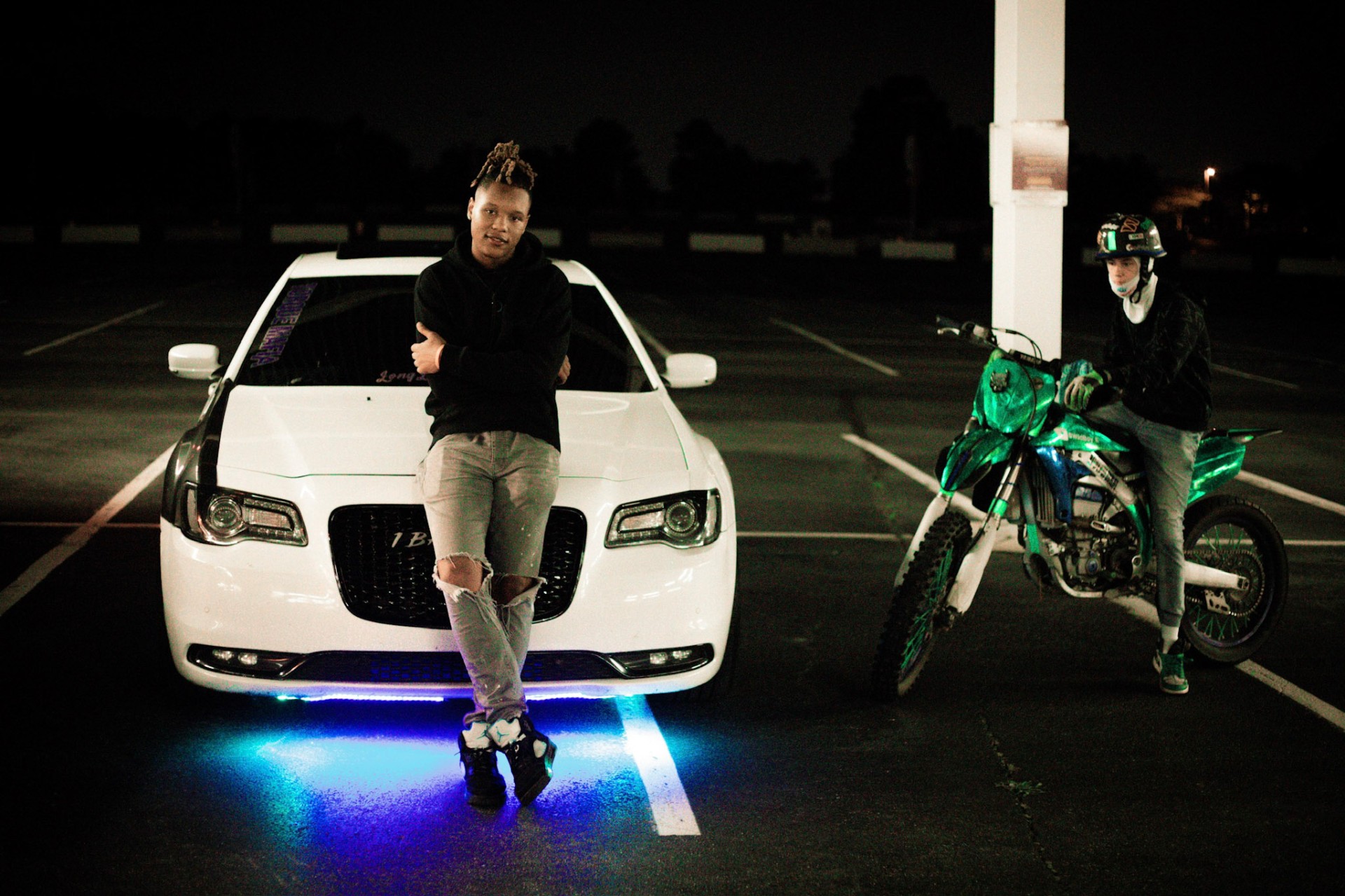 Late-night duo — Chrysler 300 and neon dirt bike