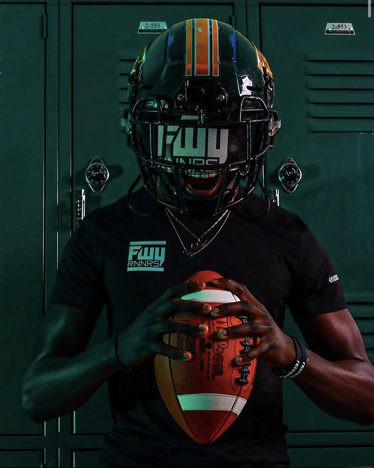 Athlete in FWY Runners gear with football
