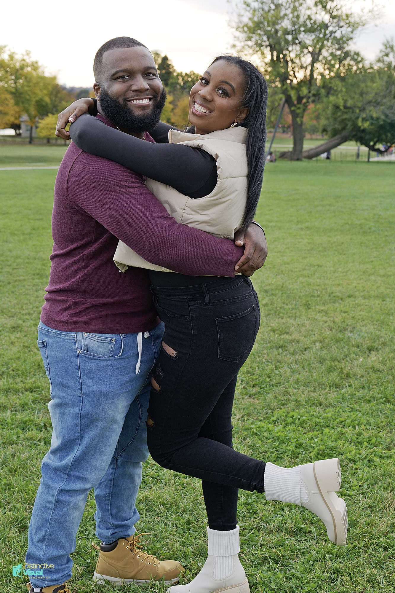 Newly engaged couple embrace at golden hour