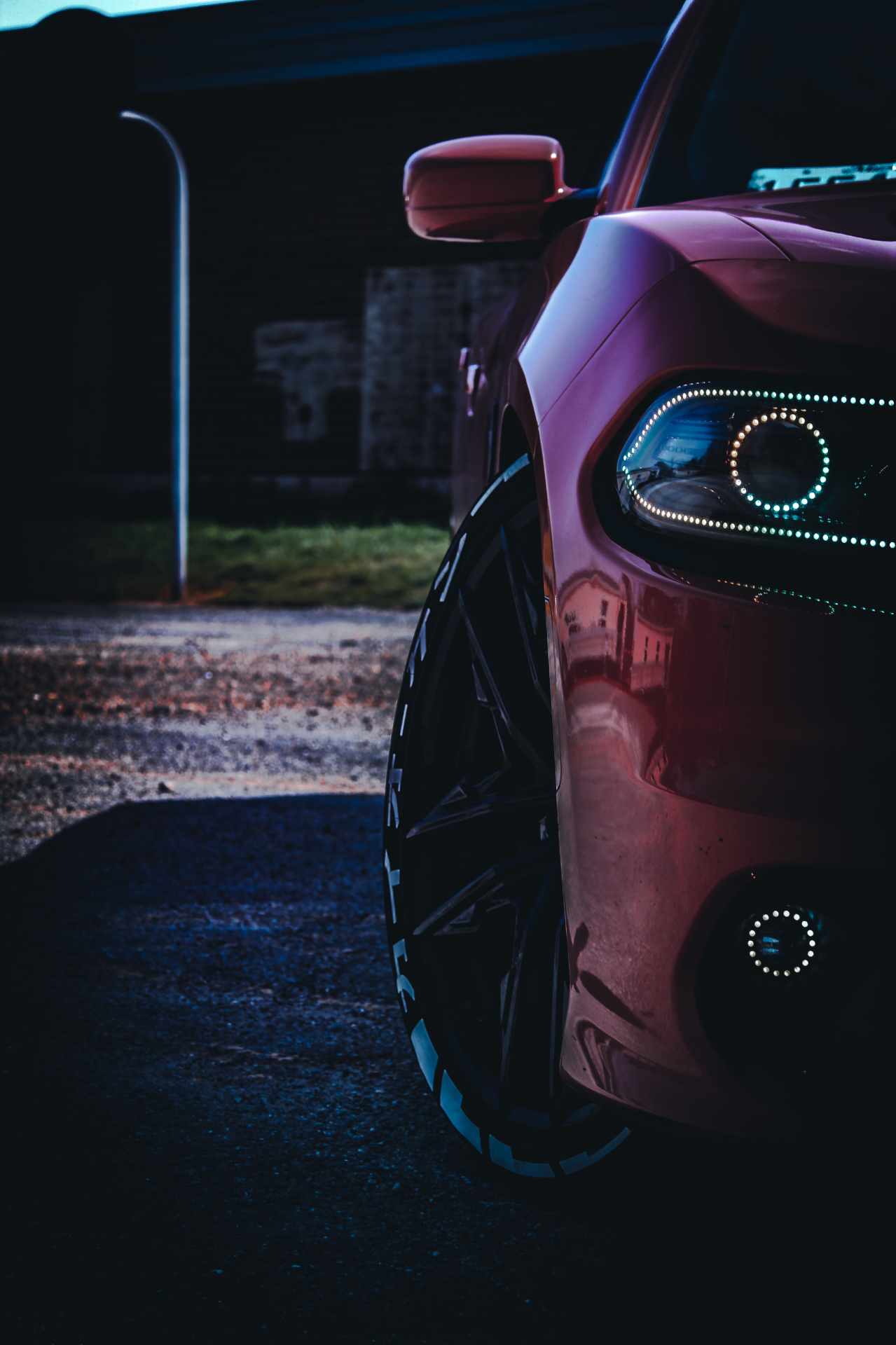 Moody automotive detail — front wheel and headlight